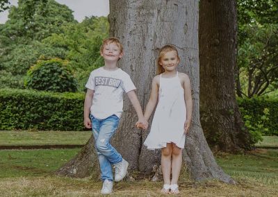 Boy and girl against tree